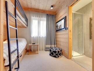This cozy bedroom features a bunk bed, perfect for accommodating guests or family members.