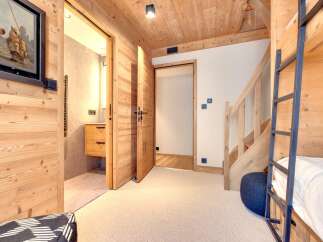 This charming property boasts a cozy interior with wooden accents throughout, creating a warm and inviting atmosphere.