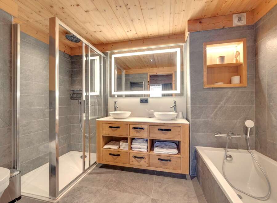 This luxurious bathroom features a modern design with a touch of rustic charm.