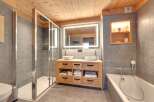 This luxurious bathroom features a modern design with a touch of rustic charm.
