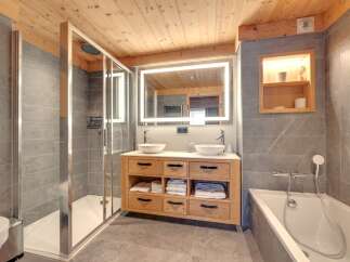 This luxurious bathroom features a modern design with a touch of rustic charm.