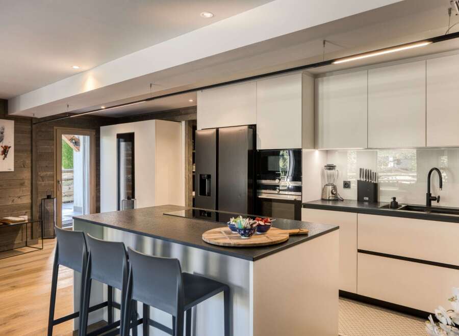 This modern kitchen boasts sleek, minimalist design with high-end appliances and ample counter space.