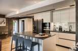 This modern kitchen boasts sleek, minimalist design with high-end appliances and ample counter space.