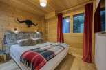 This cozy bedroom features a rustic wooden interior, creating a warm and inviting atmosphere.