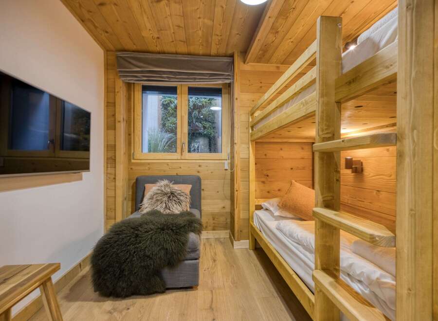 This cozy bedroom features a charming bunk bed, perfect for accommodating guests or family members.