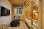 This cozy bedroom features a charming bunk bed, perfect for accommodating guests or family members.