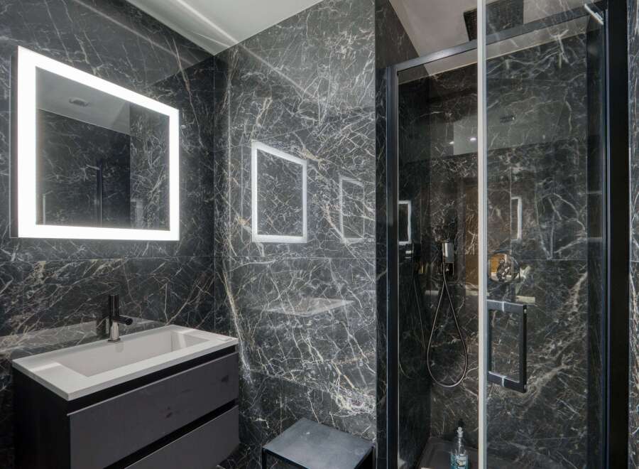 Step into luxury with this stunning bathroom featuring sleek, modern design.