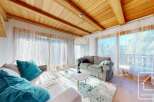 Experience luxury living in this stunning property, featuring a cozy living room with a plush sofa and vibrant teal cushions.