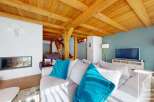 Experience the charm of this stunning property, featuring a cozy living room with a fireplace and a beautiful wooden ceiling.