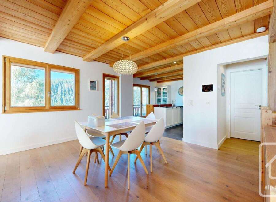 Experience the charm of this stunning property, featuring a beautifully designed dining area with a modern table and chairs.