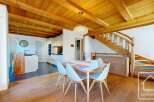 Discover the charm of this stunning property, featuring a beautifully designed interior with wooden beams and a modern kitchen.