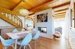 Experience luxury living in this stunning property, featuring a modern fireplace and a stylish dining area.