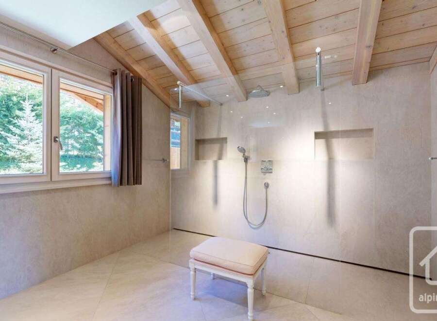 Experience luxury in this stunning bathroom, featuring a modern shower design and elegant finishes.