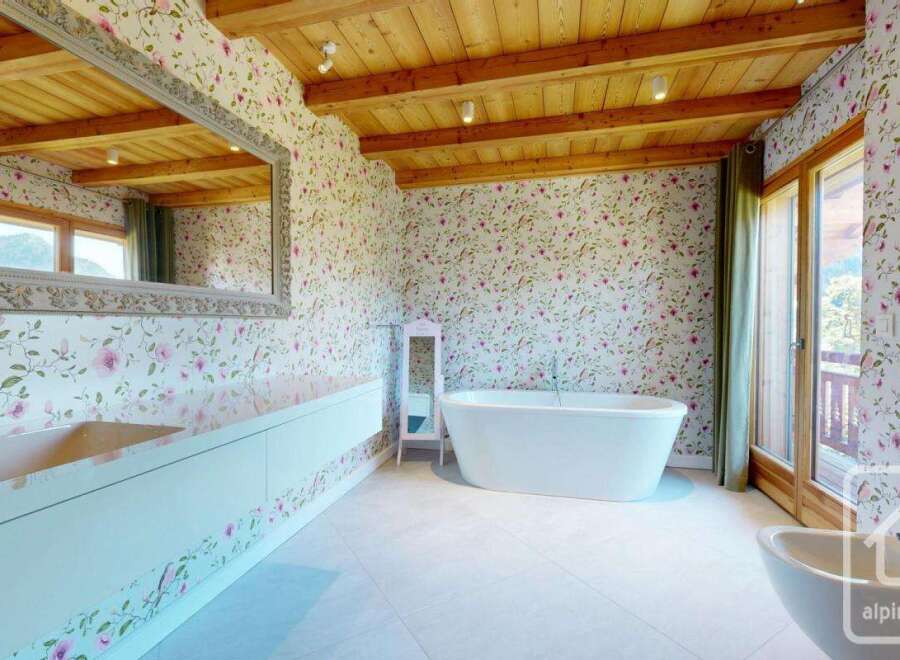 This luxurious bathroom features a freestanding bathtub, a sleek vanity, and a large mirror.