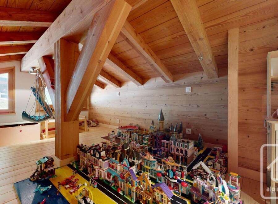 Discover the charm of this unique property, featuring a cozy attic space with exposed wooden beams and a playful touch.