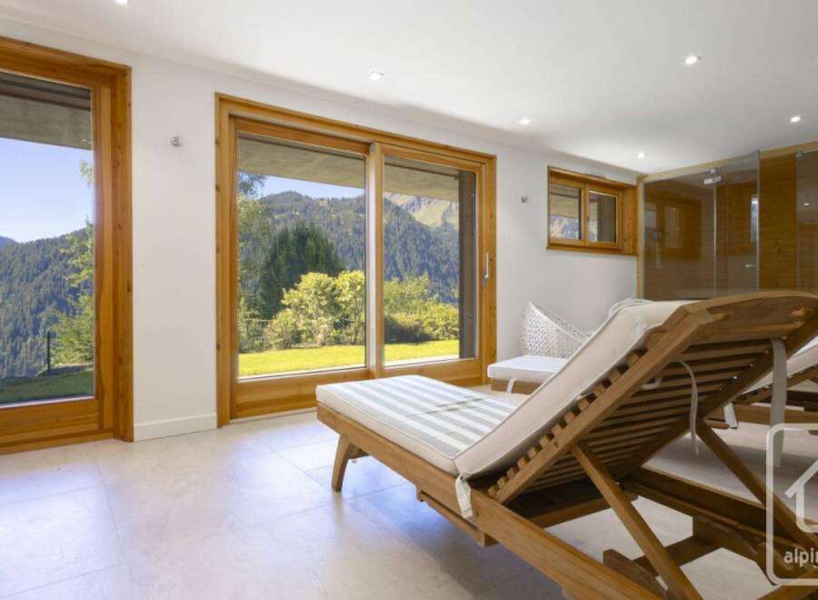 Experience the epitome of relaxation in this stunning property, featuring expansive windows that frame breathtaking mountain views.