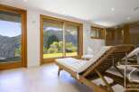 Experience the epitome of relaxation in this stunning property, featuring expansive windows that frame breathtaking mountain views.