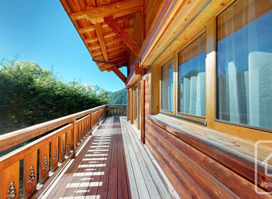 Experience the charm of this stunning property with its inviting wooden balcony and breathtaking mountain views.