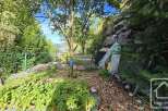 Discover a charming property surrounded by lush greenery and natural beauty.