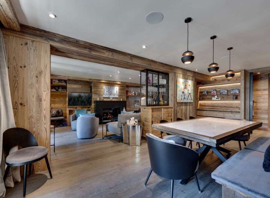 Experience luxury living in this stunning property featuring exquisite wooden paneling and a cozy fireplace, perfect for creating a warm and inviting atmosphere.