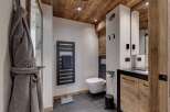 This luxurious bathroom features a modern design with rustic elements.