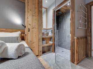 This stunning property boasts a beautifully designed bedroom with a cozy bed and a stylish bathroom.