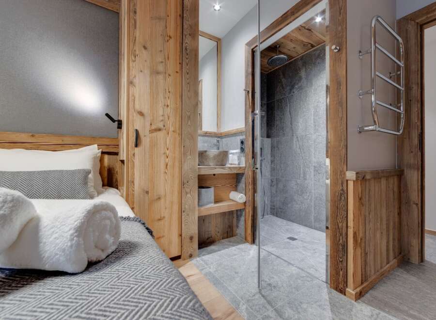 This stunning property boasts a beautifully designed bedroom with a cozy bed and a stylish bathroom.