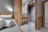 This stunning property boasts a beautifully designed bedroom with a cozy bed and a stylish bathroom.