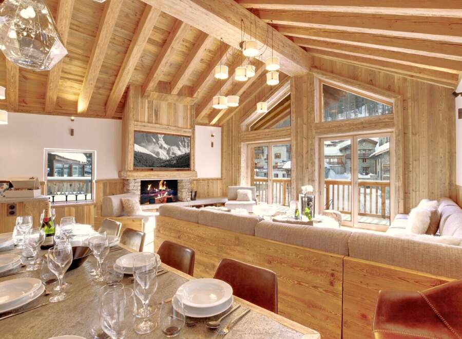 Experience luxury living in this stunning chalet, featuring a cozy fireplace and a spacious living area.