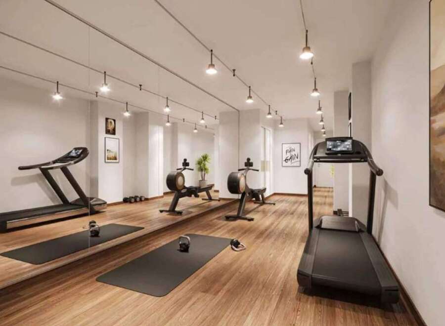 This modern gym features a variety of equipment, including treadmills and rowing machines, perfect for a comprehensive workout.