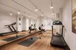 This modern gym features a variety of equipment, including treadmills and rowing machines, perfect for a comprehensive workout.
