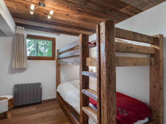 This charming bedroom features a rustic bunk bed, perfect for accommodating guests or family members.