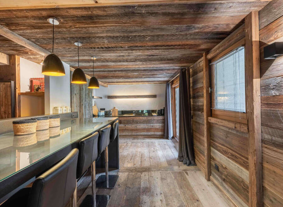 Experience rustic elegance in this stunning kitchen, featuring a beautiful wooden ceiling and walls that exude warmth and charm.