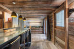 Experience rustic elegance in this stunning kitchen, featuring a beautiful wooden ceiling and walls that exude warmth and charm.