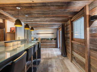 Experience rustic elegance in this stunning kitchen, featuring a beautiful wooden ceiling and walls that exude warmth and charm.