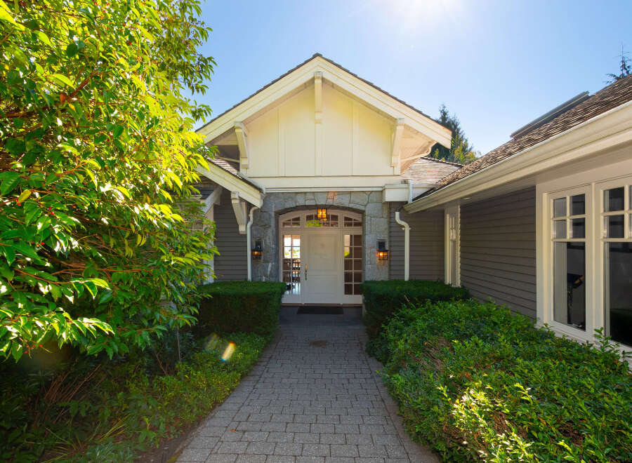 Welcome to this stunning property! This home features a beautiful stone facade and a welcoming entrance.