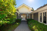 Welcome to this stunning property! This home features a beautiful stone facade and a welcoming entrance.