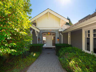 Welcome to this stunning property! This home features a beautiful stone facade and a welcoming entrance.