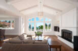 Experience luxury living in this stunning home featuring a bright and airy living room with soaring ceilings and expansive windows.