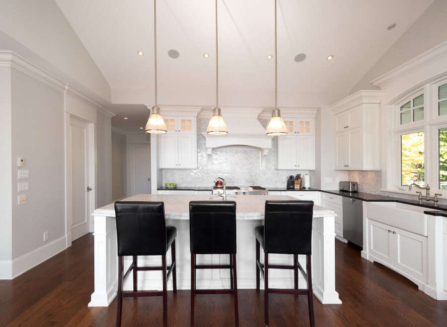 Step into this stunning kitchen, showcasing a bright and airy design with white cabinetry and a spacious island.