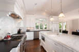 This stunning kitchen boasts a bright and airy design, perfect for culinary enthusiasts.