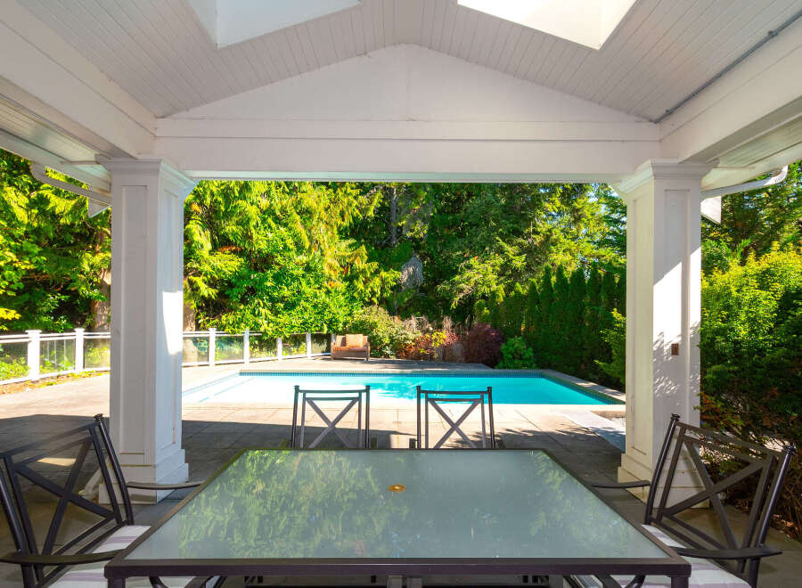 Enjoy the ultimate in outdoor living with this stunning property featuring a private pool and lush landscaping.