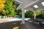 Enjoy outdoor living at its finest with this stunning property featuring a private pool and a covered patio.