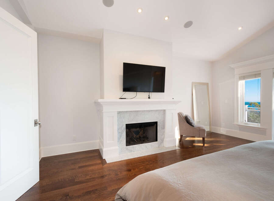 This stunning bedroom boasts a cozy fireplace, perfect for those chilly evenings.