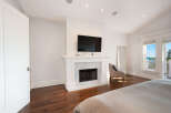 This stunning bedroom boasts a cozy fireplace, perfect for those chilly evenings.