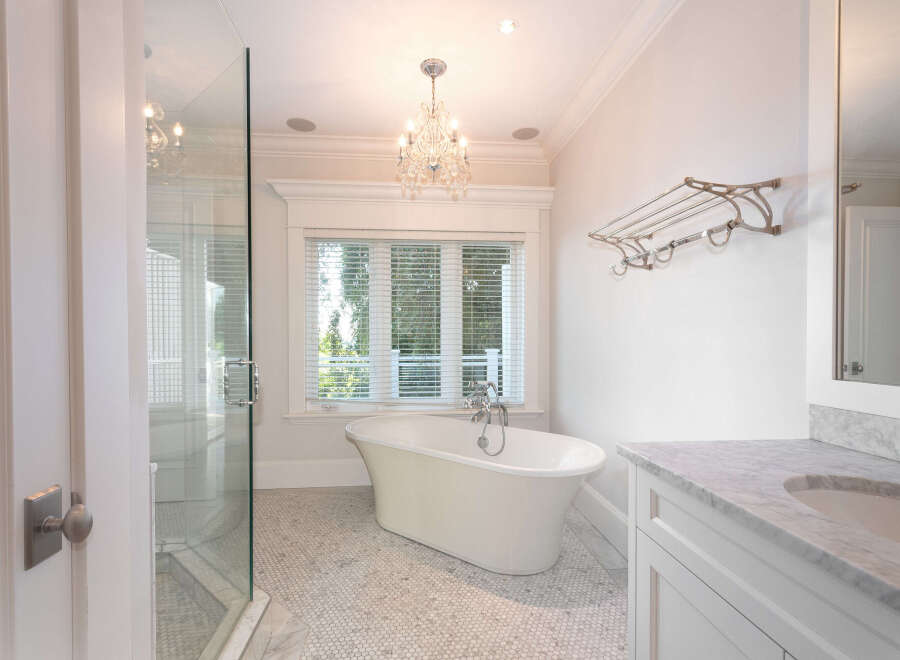 Step into luxury with this stunning bathroom featuring a classic clawfoot tub, perfect for unwinding after a long day.