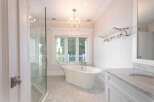 Step into luxury with this stunning bathroom featuring a classic clawfoot tub, perfect for unwinding after a long day.