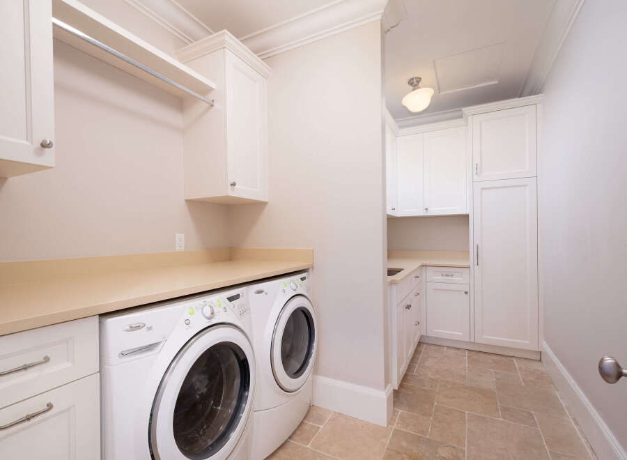 This stunning laundry room boasts modern amenities and elegant design.
