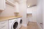 This stunning laundry room boasts modern amenities and elegant design.
