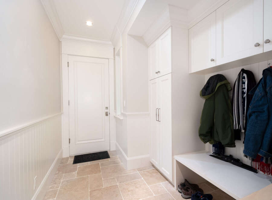 Step into this inviting entryway, featuring a stylish mudroom with ample storage.